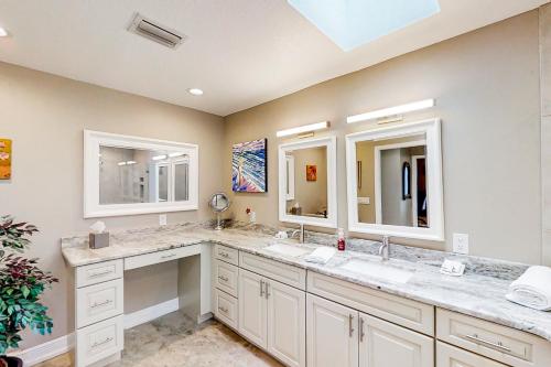 ein Badezimmer mit zwei Waschbecken und zwei Spiegeln in der Unterkunft Casa D’Arte in Port Charlotte