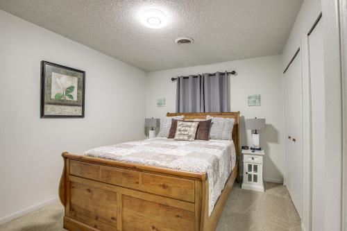 a bedroom with a wooden bed and a window at Centrally Located Apt about 2 Mi to University of Iowa in Iowa City