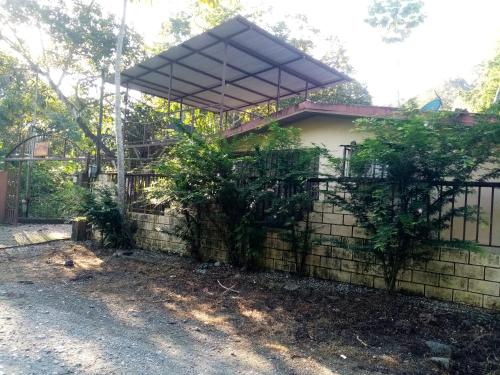 a house with a fence in front of it at La Casita in Dos Brazos