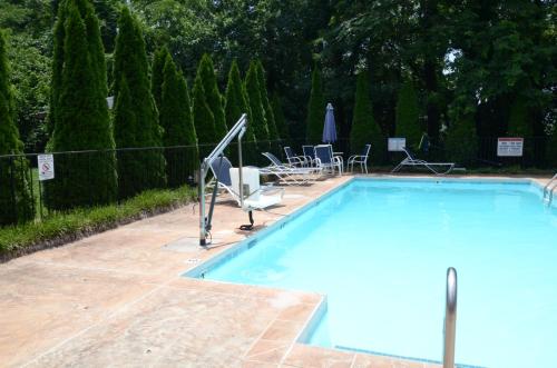 a large swimming pool with chairs at Rodeway Inn Lynchburg near University in Lynchburg
