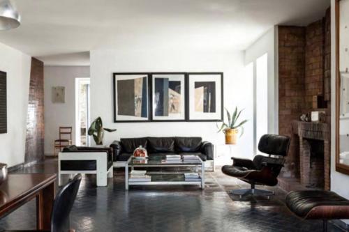 a living room with a black couch and chairs at Villa Bianca in Massa Lubrense