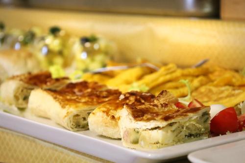 a plate of food with french fries and bread at Hotel Galimberti in Turin