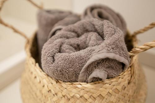 a basket filled with gray towels on a wall at Lukiskes square apartments (Oldtown) in Vilnius