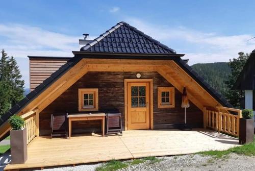 a log cabin with a desk on a deck at Beim Bergbauer in Fischbach