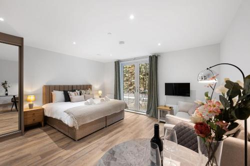 a bedroom with a bed and a living room at The Haddon Studio - Apartment 7 in Tideswell