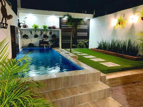 a swimming pool in the middle of a garden at Casa Naty in Ciudad Valles