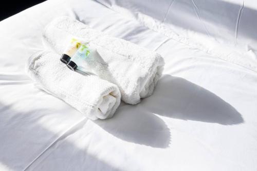 a pair of white towels on a bed at Remarkable 2- Bed House in Barking Essex in Thamesmead