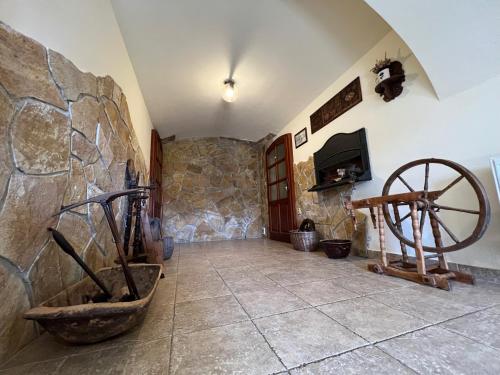 a room with a stone wall and a stone wheel at Penzion Stanský Mlýn in Hlinsko