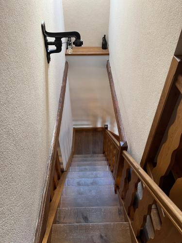 a stairway with a black hand rail and wooden stairs at Penzion Stanský Mlýn in Hlinsko