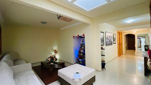 a living room with a christmas tree in the middle at Espaço Nobre in Cunha
