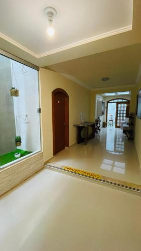 an empty living room with a large glass window at Espaço Nobre in Cunha