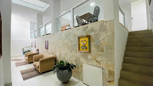 a living room with a stone wall at Espaço Nobre in Cunha