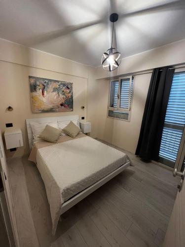 a bedroom with a bed and a ceiling at San Rocco Rooms in Palmi