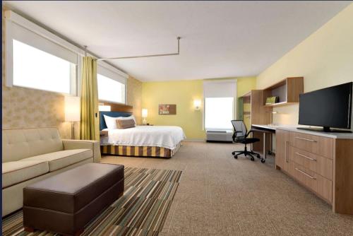 a hotel room with a bed and a desk at Home2 Suites By Hilton-Cleveland Beachwood in Beachwood