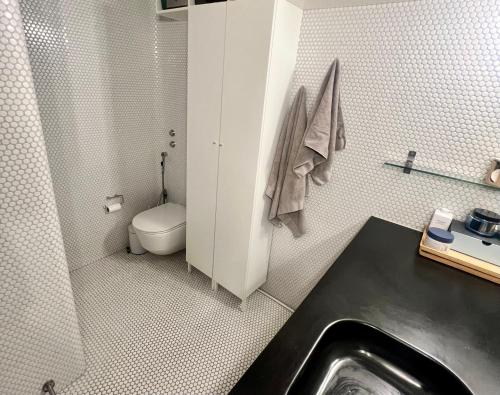 a bathroom with a sink and a toilet in it at Copenhagen in 8tallet in Copenhagen