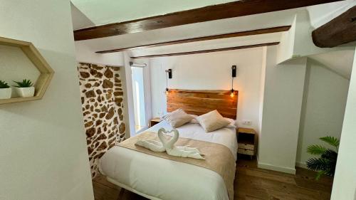 a bedroom with two white shoes on a bed at La Casucha de Chulilla in Chulilla