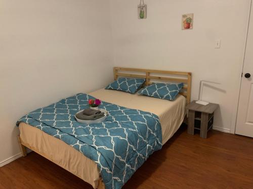 uma cama com um edredão azul com um chapéu em Private room near downtown Dallas2 em Dallas