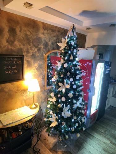 a christmas tree in the corner of a living room at Vila Rajska ptica in Bled