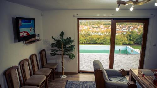 a waiting room with chairs and a view of a pool at Zivinice Hills in Živinice