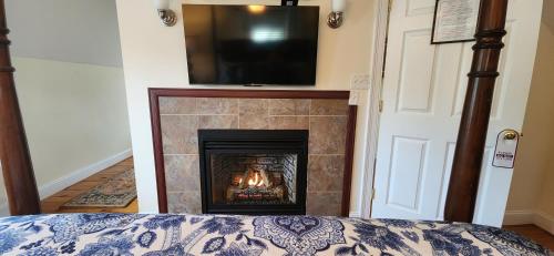 a fireplace with a television on top of it at Elmere House Bed & Breakfast in Wells