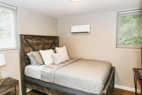 a bedroom with a bed with white sheets and pillows at Newly Renovated Small Town Retreat in Maiden