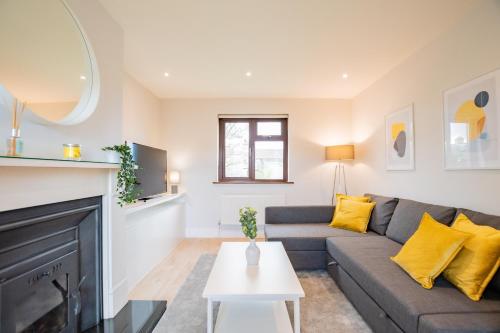 a living room with a couch and a fireplace at City Centre House With Parking in Galway