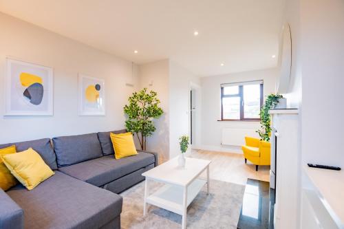 a living room with a couch and a table at City Centre House With Parking in Galway