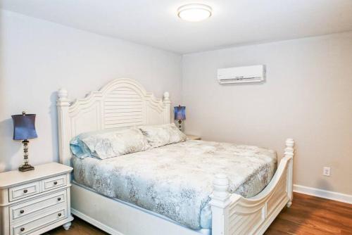 a bedroom with a white bed and a dresser at Farm Lodge with Beautiful Open Floor Plan in Lincolnton