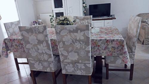 a dining room table with two chairs and a table with a table cloth at DIMORA MAJELLA in Chieti