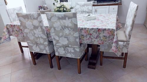 a dining room table with chairs and a table cloth at DIMORA MAJELLA in Chieti