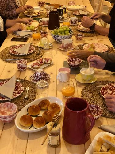 a group of people sitting around a table with food at Antica Masseria le Monache in Grottaglie