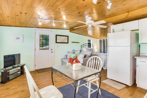 a kitchen and living room with a table and a refrigerator at Herron's Nest in Pensacola