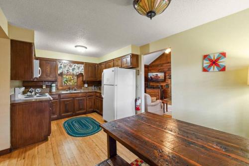 a kitchen with a wooden table and a refrigerator at Quiet cabin in the High Country in Blowing Rock