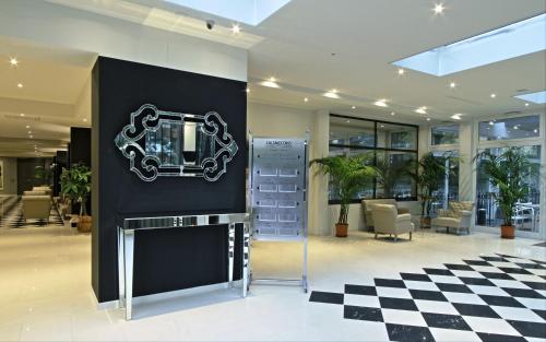 a lobby with a black and white checkered floor at Boutique Hotel Calzavecchio in Casalecchio di Reno