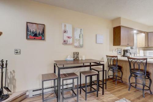 a kitchen with a table and chairs in a room at Piers and Pines at Island Pointe in Wisconsin Dells