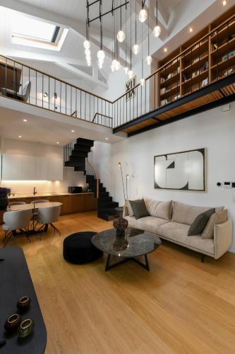 a living room with a couch and a table at Boutique Archaeological Museum Suites in Athens