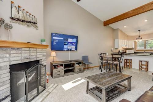 a living room with a fireplace and a tv at Grace Jo Vacation Home at Tamarack Highland 5 in Wisconsin Dells
