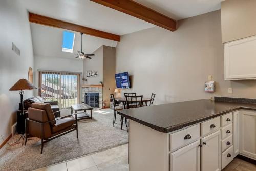a kitchen and living room with a table and chairs at Grace Jo Vacation Home at Tamarack Highland 5 in Wisconsin Dells