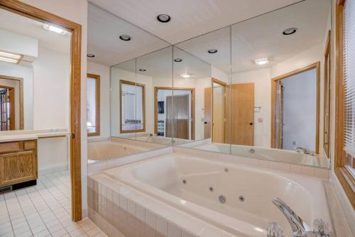 a large bathroom with a large tub and mirrors at Wisconsin Dells Escape - Amazing Views - Pools in Wisconsin Dells