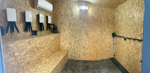 a bathroom with a stone wall with knives on the wall at Polana Modraszek in Lasowka