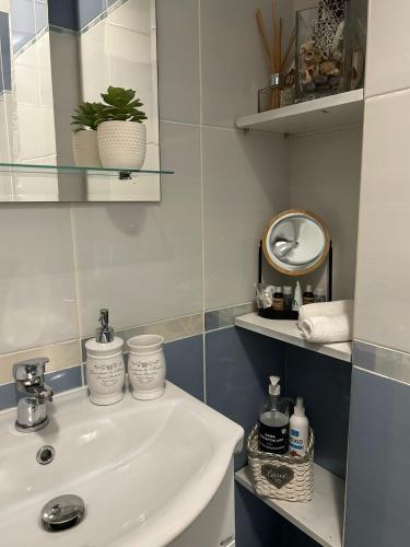 a bathroom with a sink and a mirror at Angel apartament in Sibiu
