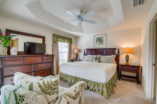 a bedroom with a bed and a dresser and a tv at Screened Lanai and Grill Home in The Villages in Wildwood