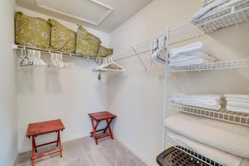 a walk in closet with white towels and a stool at Screened Lanai and Grill Home in The Villages in Wildwood