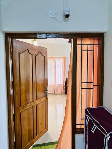 a room with an open door and a room with a room at Soorya Madhavam Apartment Guruvayur - 200 m from temple walkable in Guruvāyūr