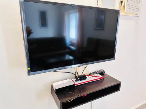a flat screen tv hanging on a wall at Soorya Madhavam Apartment Guruvayur - 200 m from temple walkable in Guruvāyūr
