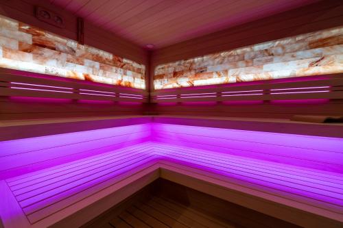 a sauna with purple lights in a room at Piastun SPA&Wellness Krynica-Zdrój in Krynica Zdrój