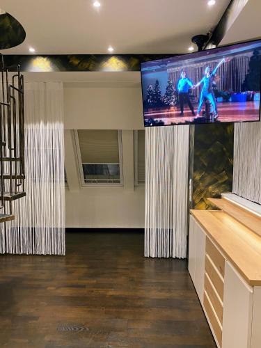 a stage with a large screen in a room at Loft im Turm in Maishofen