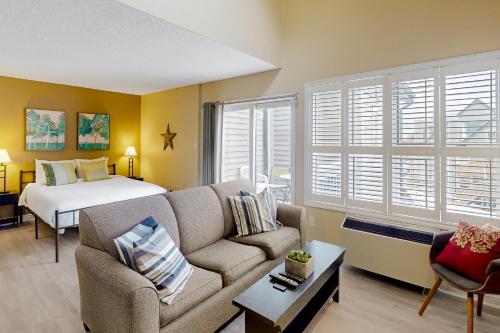 a living room with a couch and a bed at Condo 816 at North Creek Resort in Blue Mountains
