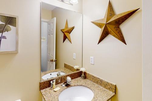 a bathroom with a sink and two stars on the wall at Condo 816 at North Creek Resort in Blue Mountains