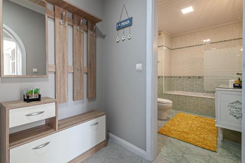 a bathroom with a toilet and a sink and a tub at VARANDAS DO MAR in Furadouro